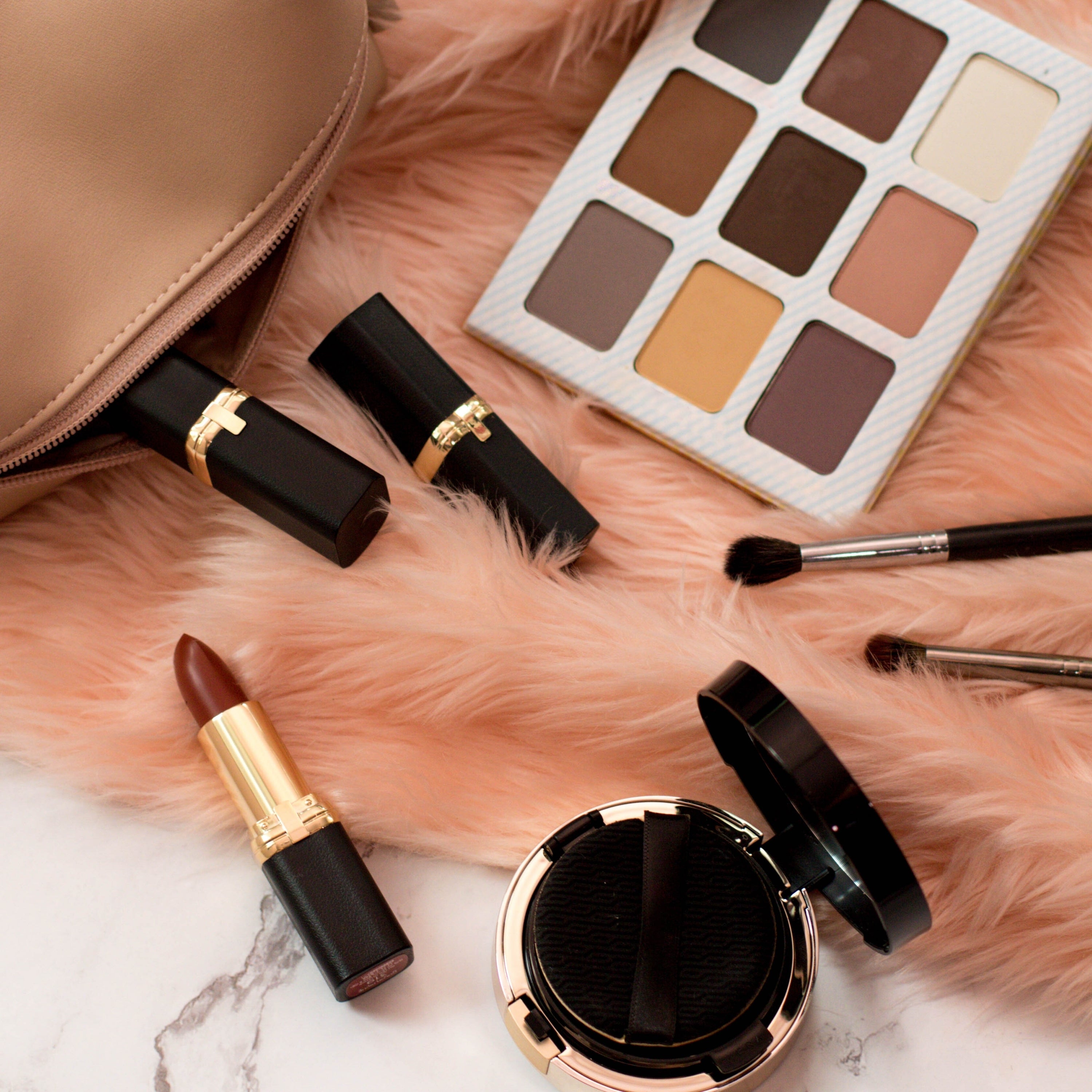 All Products beauty flatlay with makeup palette and lipsticks – Canadian Glow