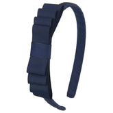 7Rainbows navy blue toddler headband with knotted bow for cute everyday wear.