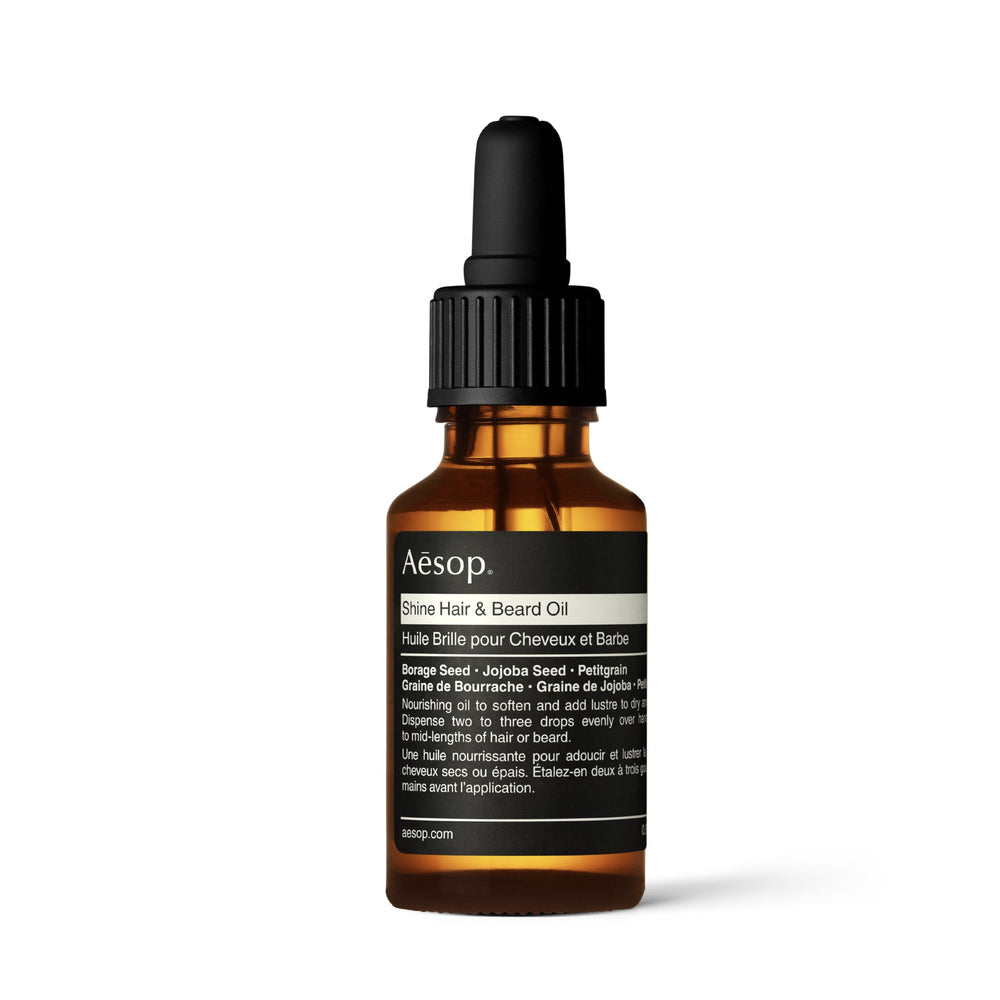 Aesop Shine Oil bottle close-up showing silicone-free hydration for smoother hair.