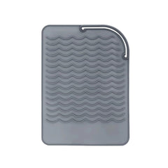 AFT90 heat resistant mat wraps curling iron to protect countertops from heat.