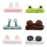 AIBFRID green frog headband keeps hair away during skincare.