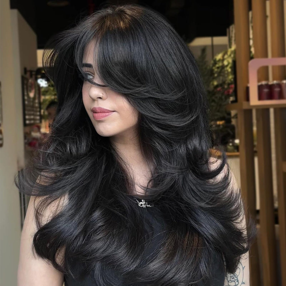 Aisaide long wavy layered wig with curtain bangs for fuller-looking hair.
