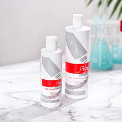 Hands applying Alra shampoo to the scalp for gentle cleansing during treatment.