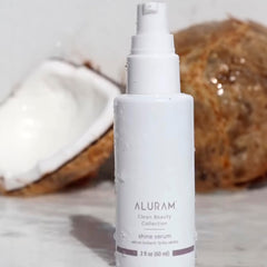 ALURAM Coconut Water Shine Serum application drop demonstrates nourishing oils