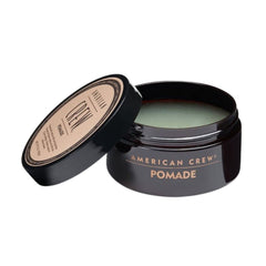 American Crew pomade demonstrates hold and shine during hair application for slick-back looks.