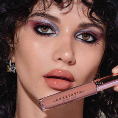 Anastasia Beverly Hills Lip Gloss Honey Kiss swatch on skin showing peachy warmth.