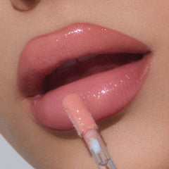Tan Rose lip gloss on lips shows a fuller-looking effect