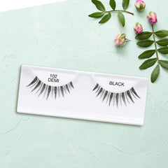 Ardell 102 Demi Black on eye look illustrates soft tapered fibers for subtle length.