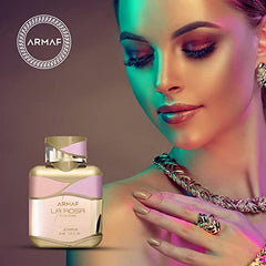 Armaf La Rosa Pour Femme bottle beside rose garden evokes fresh morning scent
