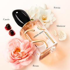Close-up of rose de mai and freesia notes signaling fresh femininity