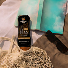 Australian Gold sunscreen lotion water-resistance montage emphasizes 80-minute swim durability.