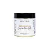 Bask and Lather stimulating scalp balm jar showcases mango and shea butter for nourishment.