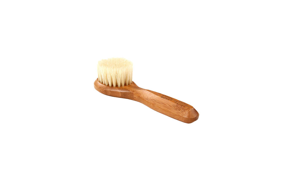 Bass Facial Cleansing Brush with natural bristle wood handle for gentle cleansing.