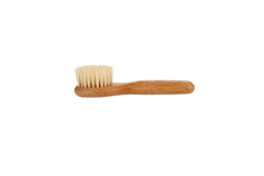 Bass Facial Cleansing Brush wood handle close-up highlighting natural bristles.