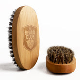 The Beard Club boar bristle brush birchwood closeup for even oil distribution and tame styling.