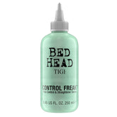 TIGI Bed Head Control Freak Serum bottle on wet hair for frizz control.