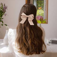 Bessrung hair accessory in wedding setting with elegant brown bow.