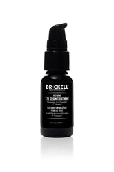 Brickell Men's Dark Circle Eye Serum bottle being applied to reduce under-eye puffiness.