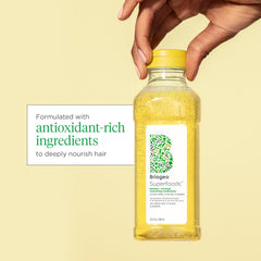 Close-up of Briogeo shampoo bottle highlighting banana extract's strengthening properties.