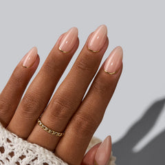 Gold foil detail on BTArtbox nails with subtle glow under indoor lighting.