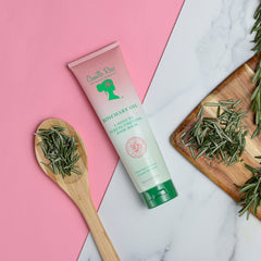 Camille Rose Rosemary Oil ingredients closeup showcases rosemary and biotin blend