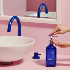 Capri Blue Volcano hand wash pump in action, delivering creamy lather.