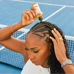 Carol's Daughter Goddess Strength oil massaging scalp during treatment for curls.