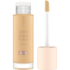 Catrice Soft Glam Filter Fluid bottle on a clean surface with radiant glow.