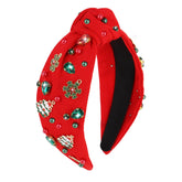 Cavetee Christmas headband worn by a woman with red knot and rhinestones for festive sparkle.