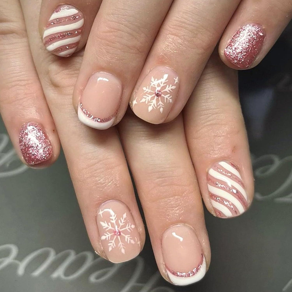 Christmas press on nails with white snowflake design for a festive winter look.