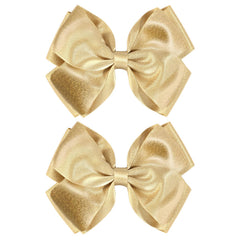 CN gold glitter hair bow clip closeup with shimmering satin finish for party-ready sparkle