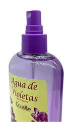 Crusellas Agua de Violetas pump spray on shelf, suggests soothing skin refreshment and calming ambiance.