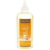 Cuccio Naturale Revitalizing Cuticle Oil bottle close-up for overnight hydration.