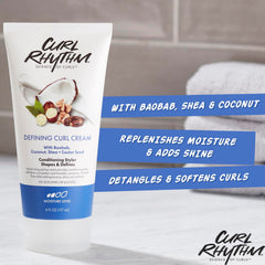 Curl Rhythm Defining Curl Cream bottle in hand demonstrates humidity resistance.