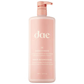 DAE Signature Conditioner bottle pouring for smooth hydration and frizz control.
