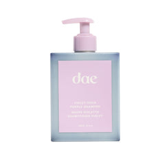 DAE Violet Hour Purple Shampoo bottle shows color-correcting action for brassiness in blonde and gray hair.