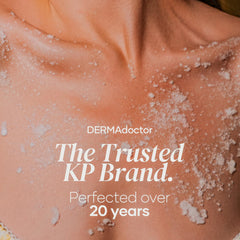 DERMAdoctor KP Bump Eraser Scrub being applied to damp skin in the shower.