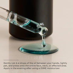DIME Beauty Blue Facial Oil on the back of a hand showing lightweight texture.