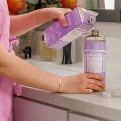 Dr. Bronner's Lavender castile soap being poured for body wash and hands.