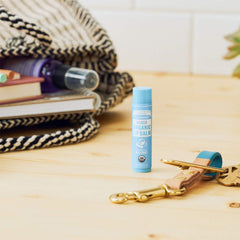 Dr. Bronner's lip balm ingredients visual highlights organic beeswax, jojoba, avocado and hemp oils