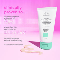 Hands applying Drunk Elephant Therabu Buttered Hand Cream with smooth, even spread.