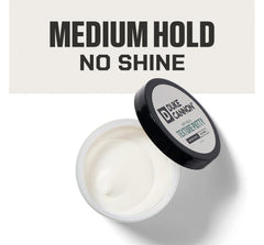 Duke Cannon Dry Hold Putty being warmed between hands for easy application.