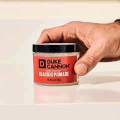 Duke Cannon Flexible pomade jar closeup highlights light natural shine.
