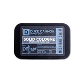 Duke Cannon Midnight Swim solid cologne tin closeup shows compact travel-ready scent