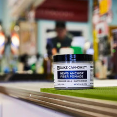 Duke Cannon News Anchor Fiber Pomade tube showing natural matte finish for versatile styling