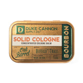 Duke Cannon Bourbon solid cologne tin front for on-the-go fragrance touch-ups.