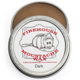 Firehouse Moustache Wax dark tin close-up shows natural color and strong hold.