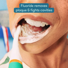 Frida toothpaste pea-sized portion on toothbrush promoting proper dosing