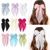 Furling Pompoms large pink satin bow clip for instant, elegant hair polish.