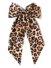 Furling Pompoms leopard hair bow camel front view showcases bold style and secure hold.